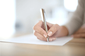 printolux-closeup-of womans-hands-writing-on-paper